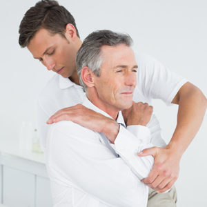 A chiropractor helps a patient